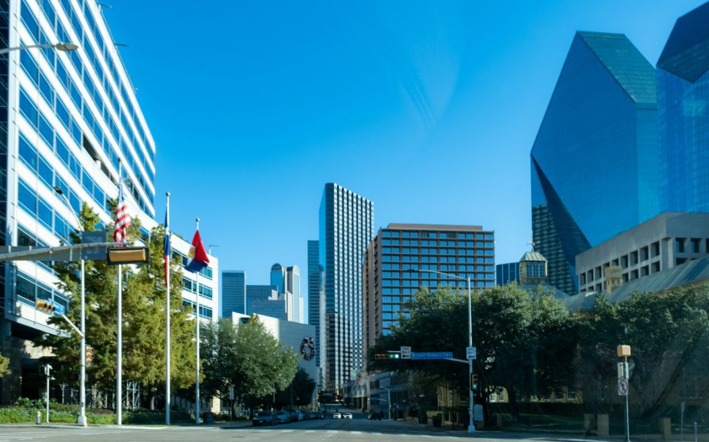 Neighborhood street with shops and tall buildings in the background